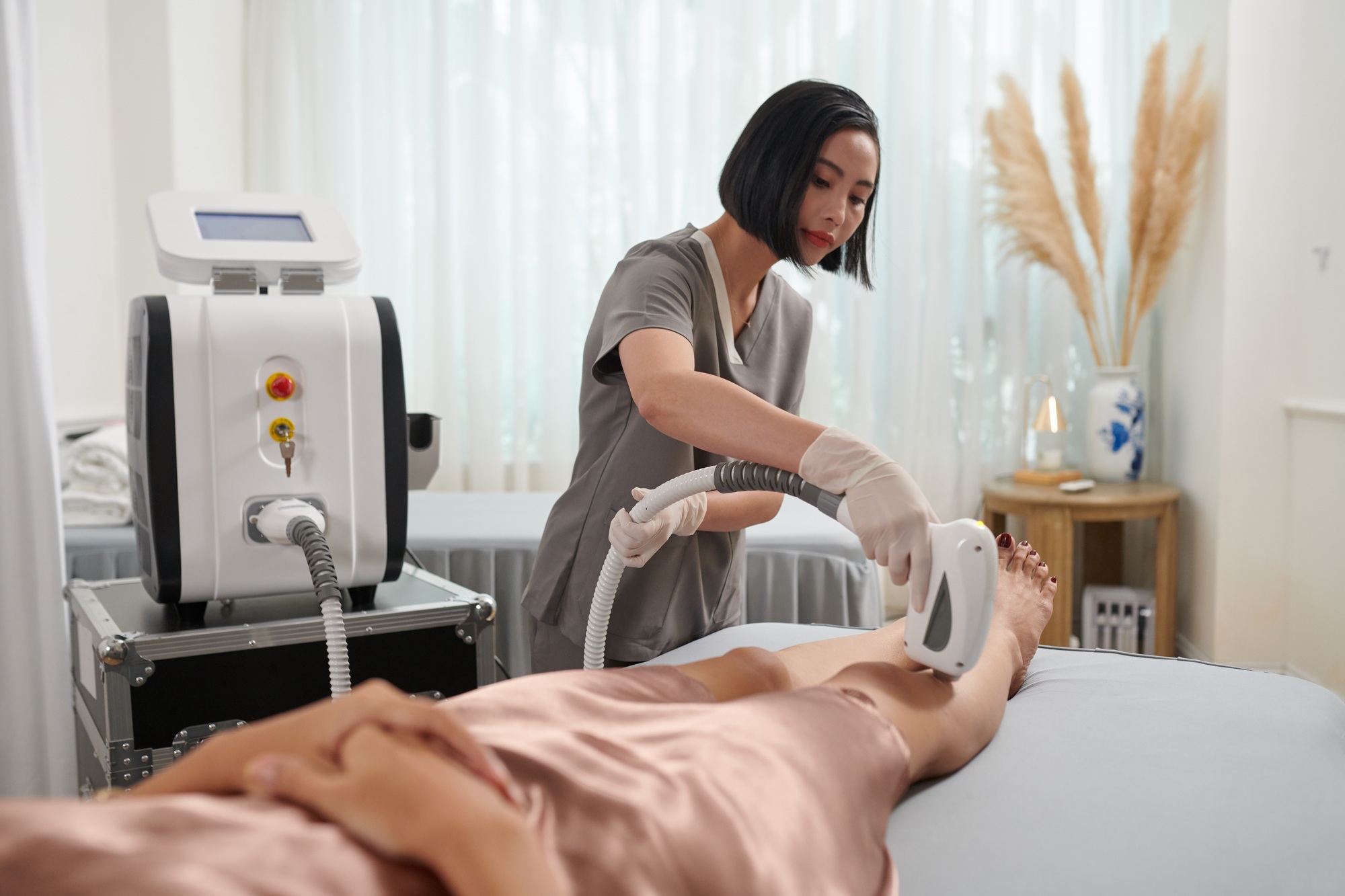 Beautician Epilating Clients Legs